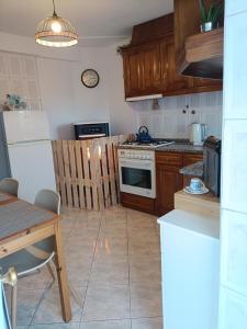 a kitchen with wooden cabinets and a stove top oven at Casa D'avó in Sabrosa