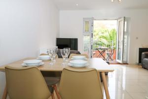 a dining room with a table with chairs and a dining room at Harbour Way in Shoreham-by-Sea