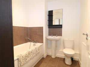 a bathroom with a toilet and a tub and a sink at Harbour Way in Shoreham-by-Sea +25 photos