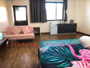 a living room with a bed and a couch at Samoa FINAU 685 Accomodations in Vaitele