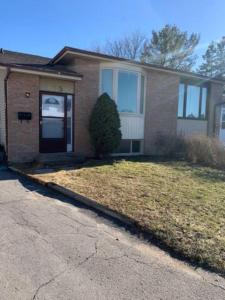 een stenen huis met een voordeur en een oprit bij Napaeno's Place - Home Away from Home in Kingston