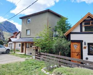 a house with a fence in front of it at Chaltén Apart 365 in El Chalten