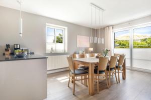 a kitchen and dining room with a table and chairs at Inselhuus Fehmarn 2 in Petersdorf auf Fehmarn