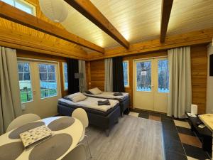 ユヴァスキュラにあるVilla Tourulaのベッド2台とテーブルと椅子のある寝室