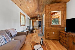 ein Wohnzimmer mit Sofa und Fernseher in der Unterkunft Hot Tub - Sit and Stay Cabin in Red River Gorge KY in High Falls + 21 Fotos