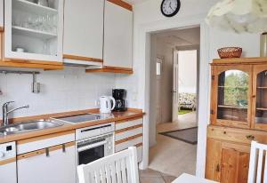 a kitchen with a sink and a stove top oven at Mala in Landkirchen