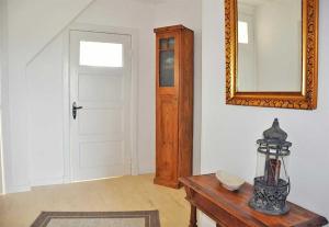 a room with a mirror and a table and a door at Mala in Landkirchen +12 photos