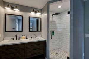a bathroom with two sinks and a shower at Rhododendron Rendezvous in Blowing Rock +47 photos