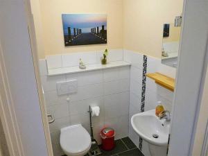 a small bathroom with a toilet and a sink at Haus Wellenkamp in Burg auf Fehmarn