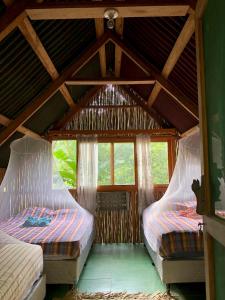 Ένα ή περισσότερα κρεβάτια σε δωμάτιο στο Tuqtuquilal - Cacao & Regenerative Center