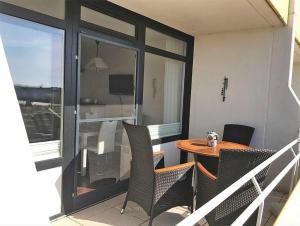 un balcon avec une table et des chaises dans une pièce dans l'établissement OASE in Burgtiefe, à Burgtiefe auf Fehmarn 