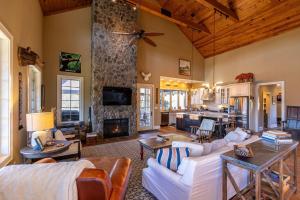 a living room with couches and a stone fireplace at Robin Hoods Retreat in Jefferson