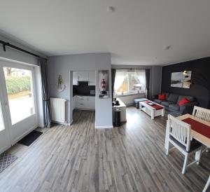 a living room with a couch and a table at Fiete in Marienleuchte