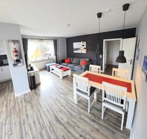 a living room with a table and chairs and a couch at Fiete in Marienleuchte