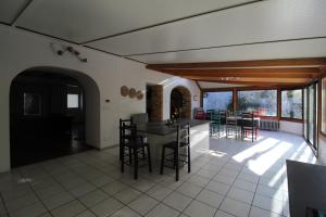 a kitchen and living room with a table and chairs at Maison en pierre 4 chambres 