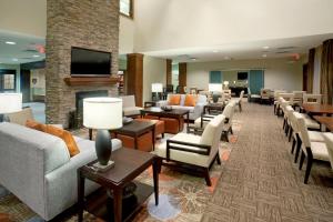 a lobby with couches and chairs and a fireplace at Staybridge Suites San Antonio-Stone Oak by IHG in San Antonio