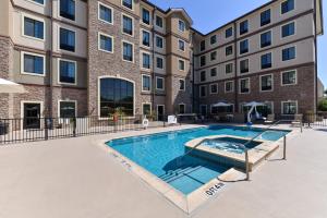 a swimming pool in front of a building at Staybridge Suites San Antonio-Stone Oak by IHG in San Antonio