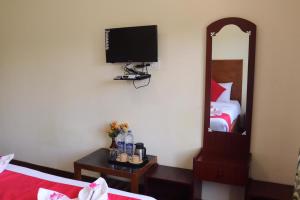 a hotel room with a bed and a mirror at Life style home stay in Kodaikānāl