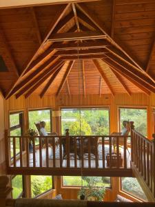 a large room with a wooden ceiling and windows at Beautiful Plot Lake and Volcano View in Puerto Varas