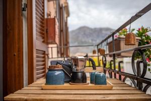 a tea kettle and cups on a table on a balcony at Casamè Apartment Sulmona - a due passi da centro, free bike park in Sulmona
