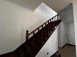 a staircase in a house with a white wall at The Shan Guest House in Nugegoda