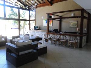 a living room with a couch and a bar at Pousada Praia Bella in Búzios