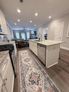 een keuken met witte kasten en een aanrechtblad bij War Eagle Landing a 4BR and 3BA Family-Friendly Auburn Retreat in Auburn