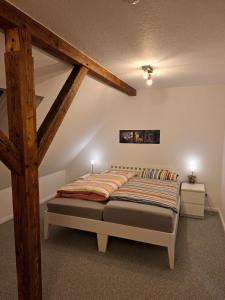 a bedroom with a large bed in a attic at Hof Nordholz in Großenkneten