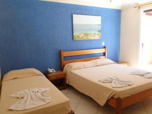 Un pat sau paturi într-o cameră la Pousada Praia Bella