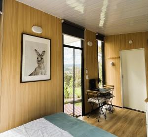 une chambre avec une photo d'un chien sur le mur dans l'établissement Kanimbla Sunsets by Tiny Away, à Kanimbla