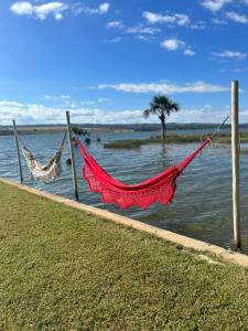 a couple of hammocks on a dock in the water at Pontal da lagoa in Planaltina +13 photos