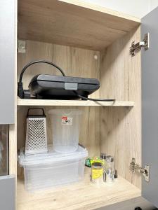 Un electrodoméstico negro sobre un estante de madera en la cocina. en Reina Apartments Skopje with FREE Parking, en Skopje 44 fotos más