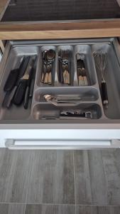 a drawer filled with utensils in a kitchen at Moderní apartmán v blízkosti centra,Wifi,Netflix in Hradec Králové +36 photos