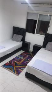 Ένα ή περισσότερα κρεβάτια σε δωμάτιο στο Appartement ville des roses