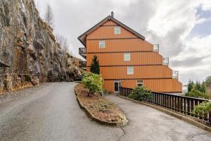 a large orange building on the side of a road at Beautiful 2-bedroom apartment in Bergen