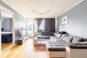 a living room with a couch and a bed at Beautiful 2-bedroom apartment in Bergen