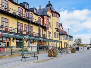 a building with benches on the side of a street at 4 star holiday home in VAXHOLM in Vaxholm