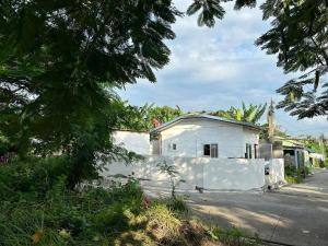 a white building on the side of a street at Staycation in Naic Cavite near Torres Farm & Beach in Naic