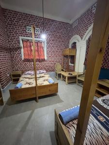a room with two bunk beds and a brick wall at Stany's apartments in Butare