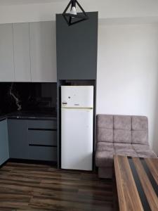 een keuken met een witte koelkast en een stoel bij kut aguest house in Koetaisi