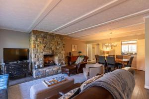 Valle CrucisにあるLakeside Living at Hound Earsの石造りの暖炉とダイニングルーム付きのリビングルーム