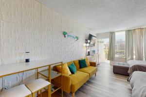 a living room with a couch and a bedroom at Skyline & Sand in Daytona Beach