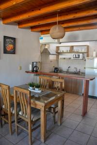 a kitchen with a wooden table and chairs in a kitchen at Edificio Mitre in Maipú +5 photos
