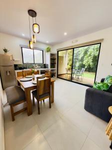 a kitchen and living room with a table and chairs at Biofilia Monteverde in Monteverde Costa Rica