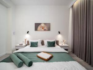 a bedroom with a large bed with green pillows at Seven Premium Apartments by Mega Mall in Almaty