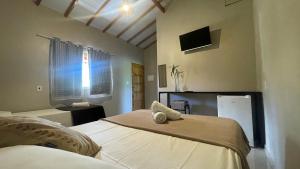 Ένα ή περισσότερα κρεβάτια σε δωμάτιο στο Pousada In Bali - Maresias