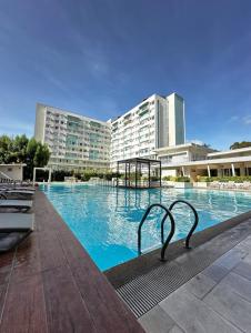 a large swimming pool in front of a large building at Norman Condominium Unit Rental in Dumaguete