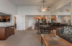 a living room with a couch and a dining room at Table Rock Lakeview Condo - Sanctuary 446 in Radical
