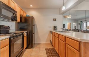 a kitchen with a stainless steel refrigerator and a sink at Table Rock Lakeview Condo - Sanctuary 446 in Radical