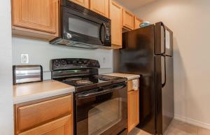 a kitchen with a black stove and a microwave at Table Rock Lakeview Condo - Sanctuary 446 in Radical +38 photos